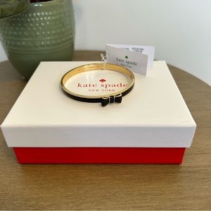 Kate Spade gold and black bow bangle. NWT includes jewelry pouch and box.